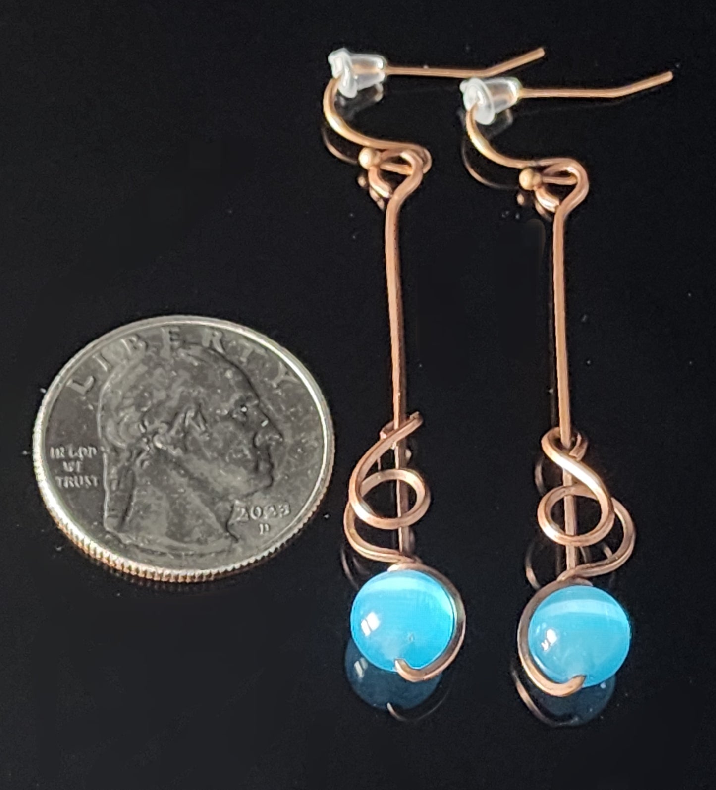 Brilliant Blue cat's eye sphere wrapped in copper wire   2" long x 1/4" wide&nbsp;   Copper wires earring hooks   Beautiful dangle earrings