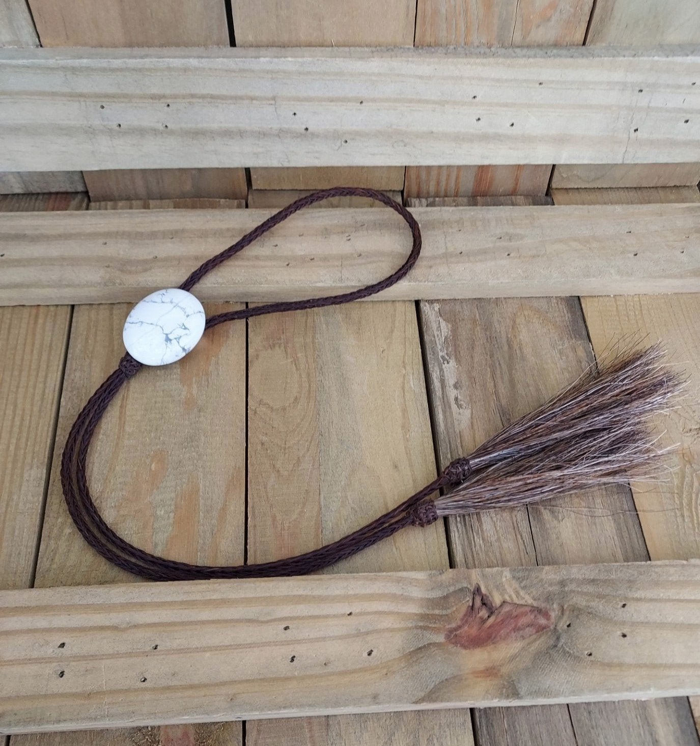 hand braided brown horsehair bolo tie with howlite cabachon stone slide with horse hair tassels