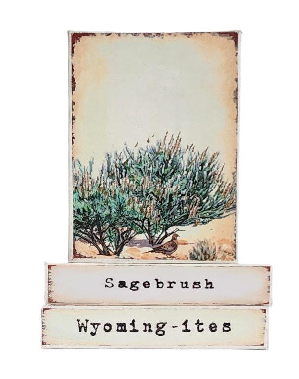 " Sagebrush Wyoming-ites" Canvas Print Artist: Catherine Holt  Print on canvas with wooden framework   Copy from artists original artwork  Sagebrush with dove   Sagebrush label on one side with Wyoming-ites on the other .  The prolific sagebrush food for many critters, especially the Pronghorn.   Wyoming-ites is a series of&nbsp; "Life in Wyoming" lifestyles and experiences!  6" long x 8" high x 1 1/2" wide  Signed and numbered by the artist