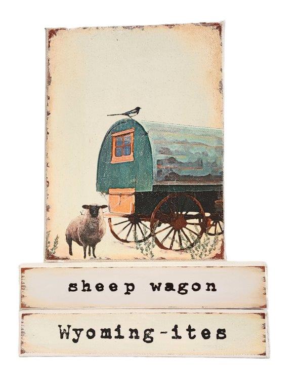 " Sheep Wagon Wyoming-ites" Canvas Print Artist: Catherine Holt  Print on canvas with wooden framework   Copy from artists original artwork   Sheep herder wagon with sagebrush and sheep in lower let   Sheep Wagon&nbsp; label on one side and Wyoming-ites label on the other  Sheep herders lived in these wagons while they tended their flock.  Wyoming-ites is a series of&nbsp; "life in Wyoming" lifestyles and experiences!  6" long x 8" high x 1 1/2" wide  Signed and numbered by the artist