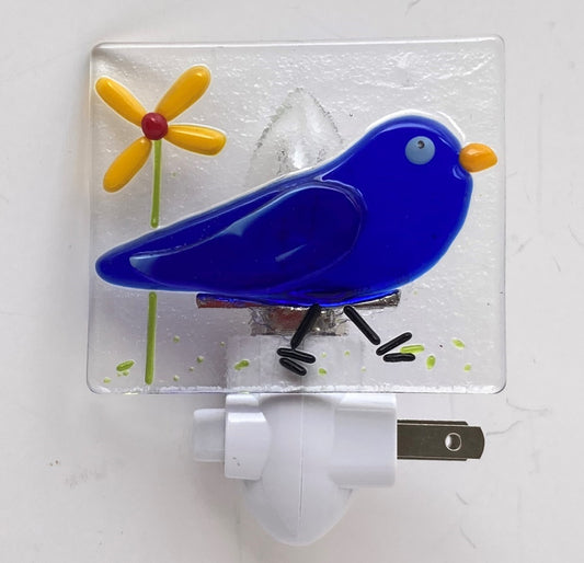 Fused Glass Nightlight  Clear glass night light with a Fused Glass blue canary bird and yellow flower  2.5" high x 3" wide x 1/4" wide fused glass  Total height of glass and nightlight is 4"  2 prong plug Beautiful fused glass art for any room   